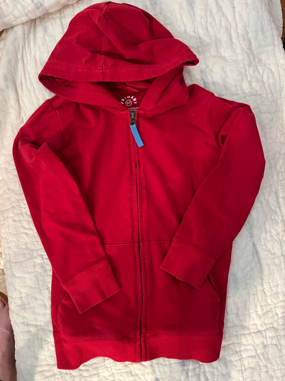 Primary red zip-up hoodie. Size 6-7.
